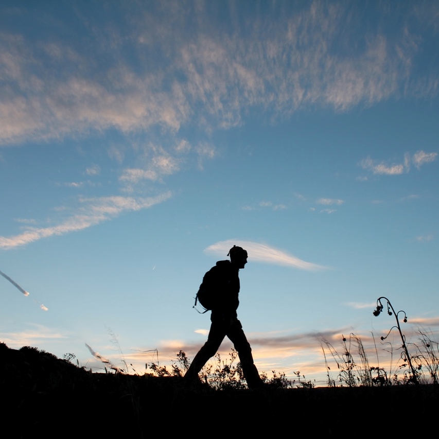 A man hiking across a ridge