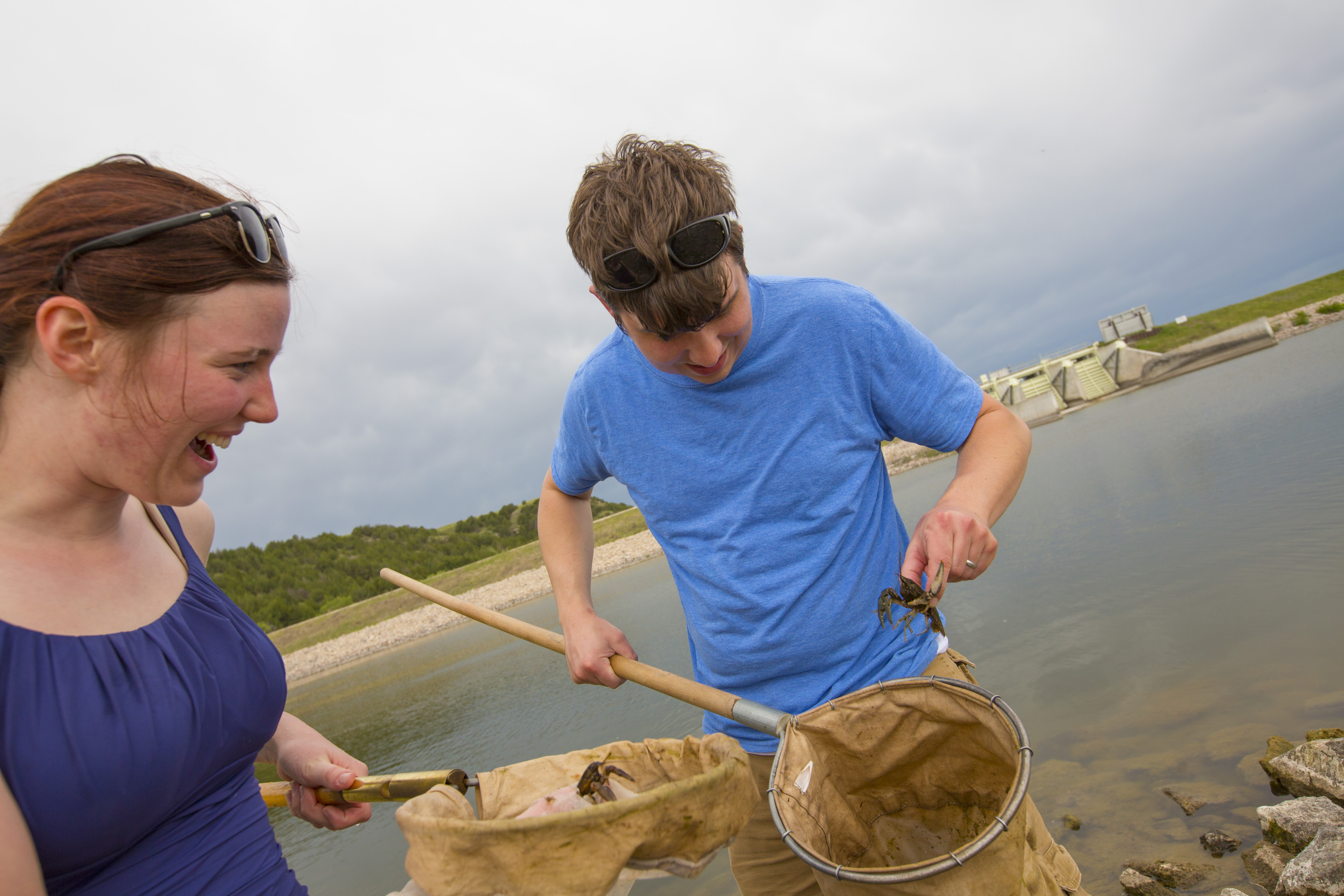 Students using dip nets to look for crayfish.