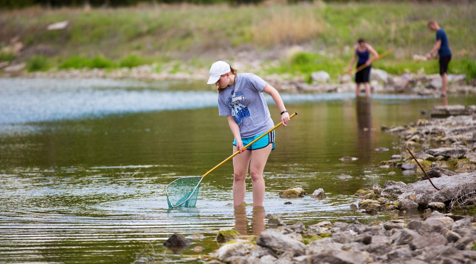 Student using net in running water