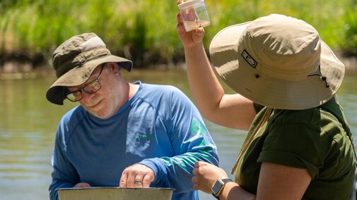 Dr. Nikol going through samples in the field with a student