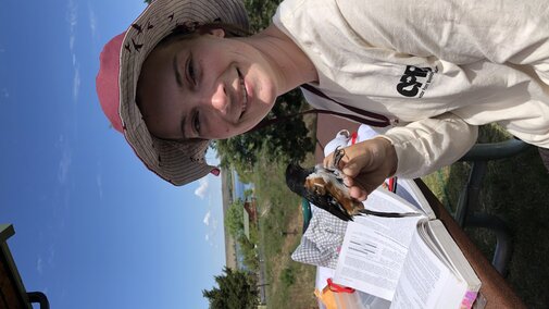 Student holding a bird